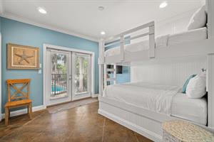 1st floor queen bedroom with access to patio, pool and backyard