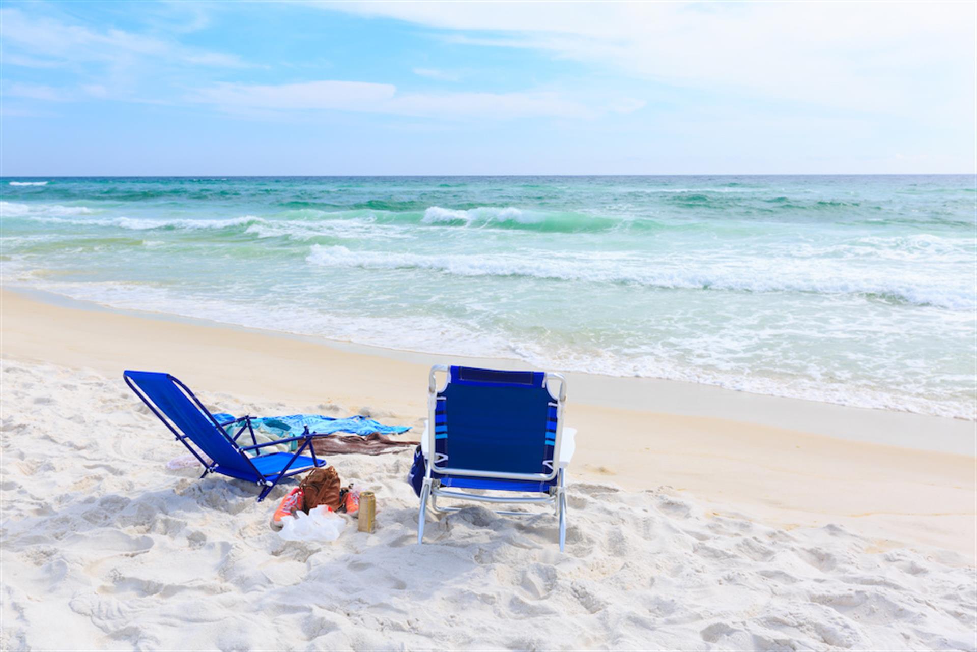 Lounge chairs on white sand Destin beach