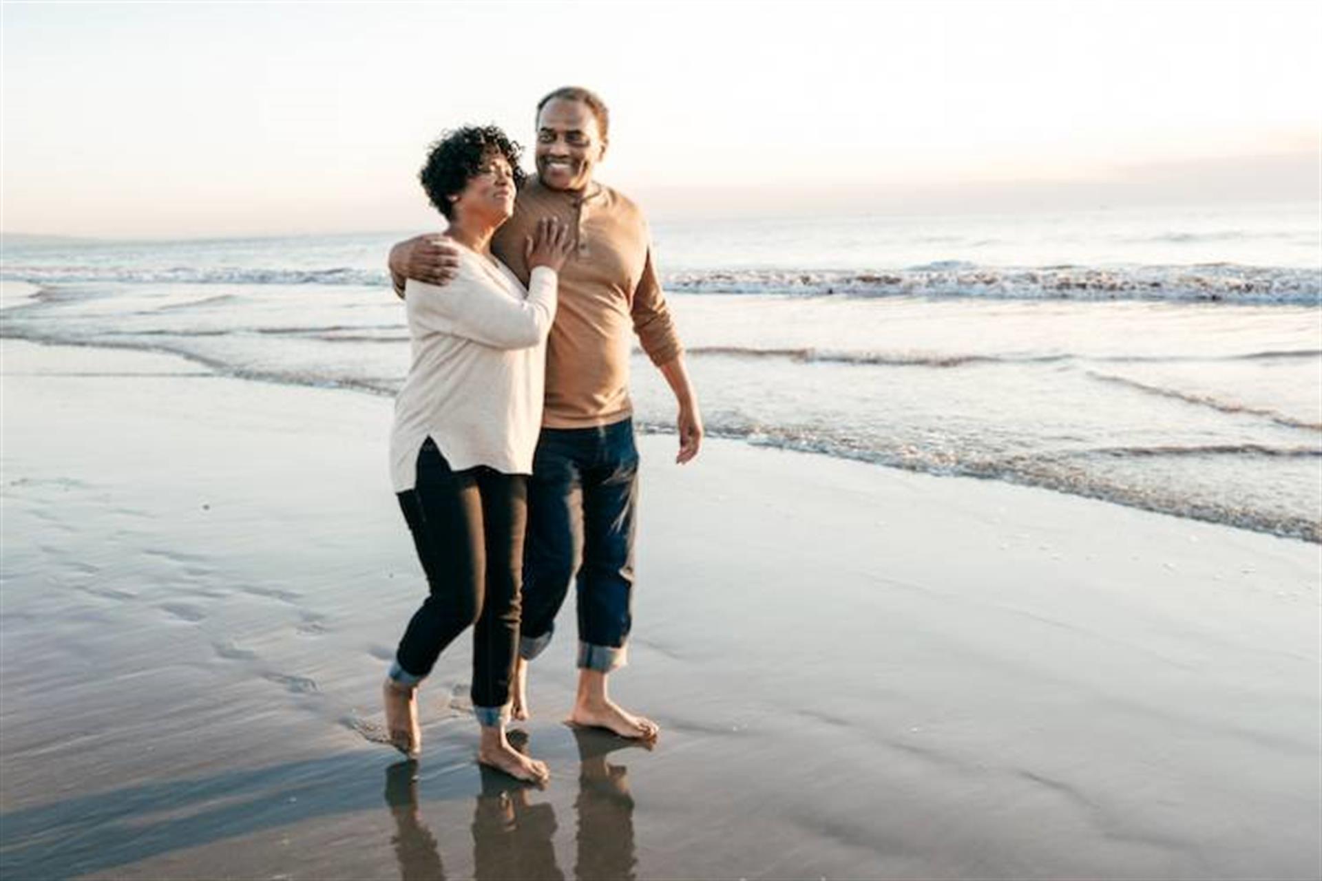 older couple walking on beach