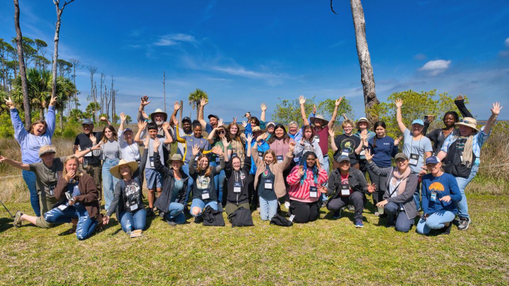 Gulf and Franklin County School students gather to cheer for a photo with Forgotten Coast en Plein Air Paint-Out artists.