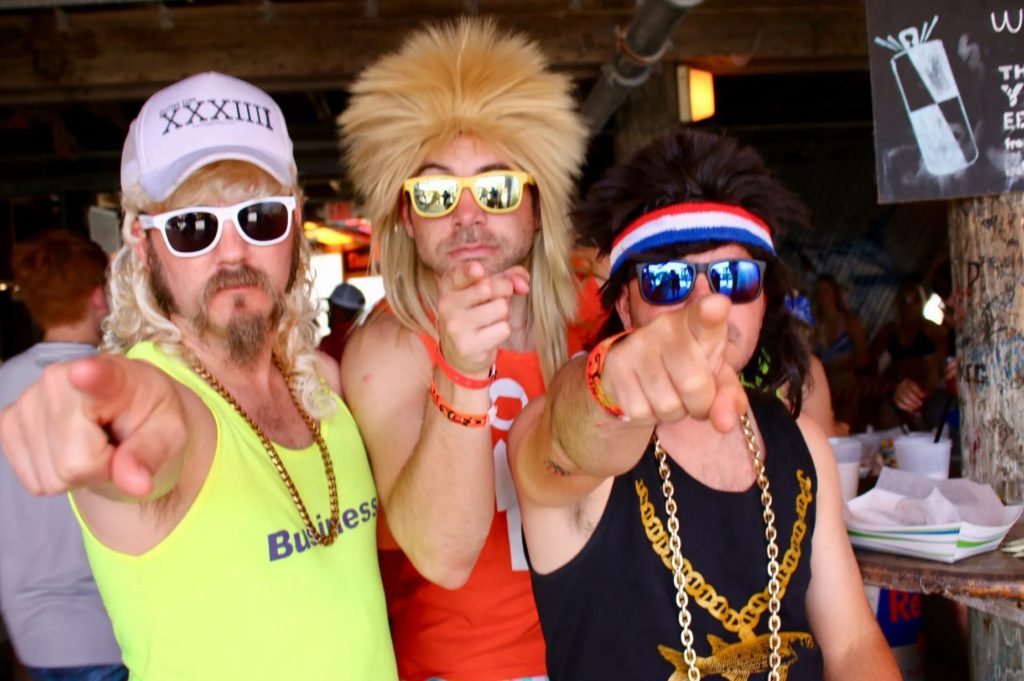 Three guys partying and pointing at the Mullet Toss