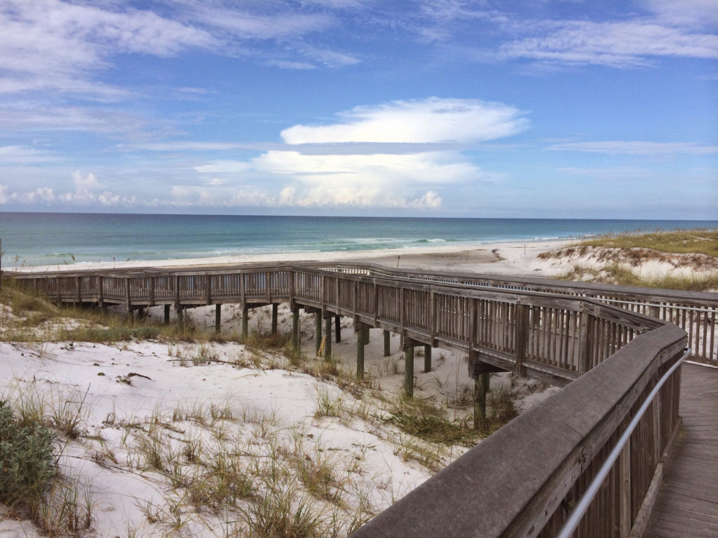 Topsail Hill Preserve State Park boardwalk crossing sand dunes.