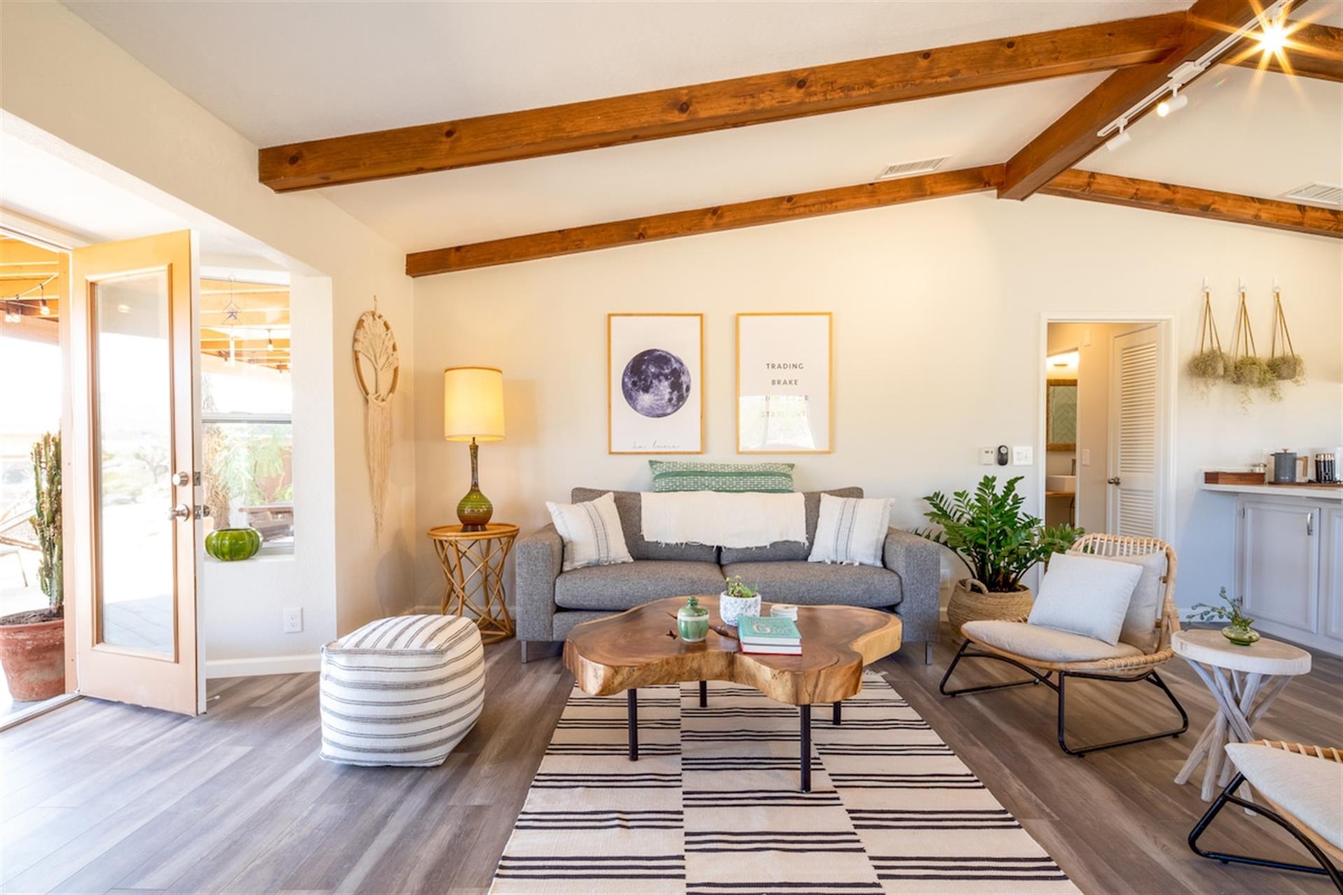 Open plan living room with doors leading to the back patio. Roomy and spacious with lots of light and a wood pellet stove for ambient heat.