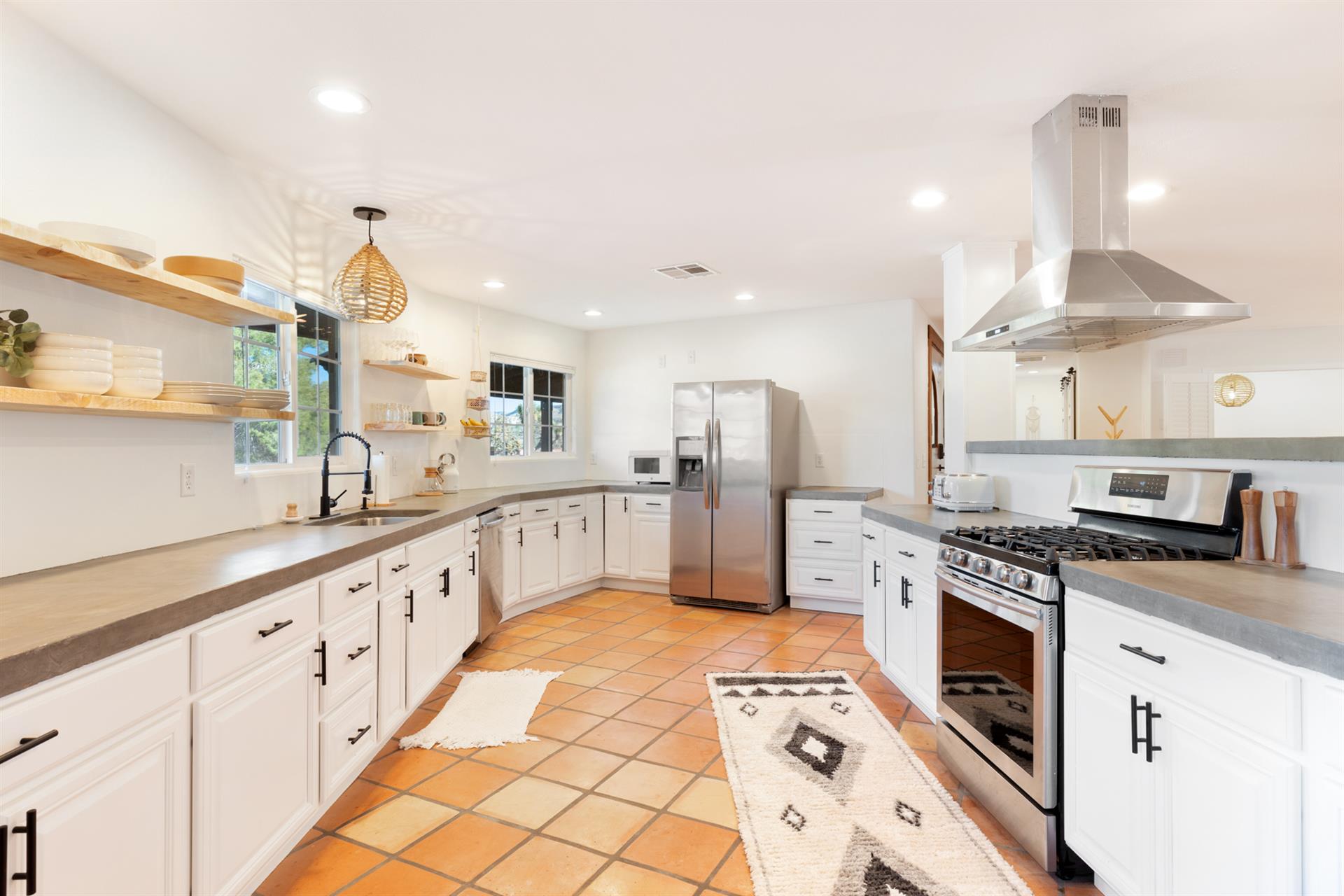 Enjoy a fully stocked and vast kitchen with ample space to prepare home cooked meals