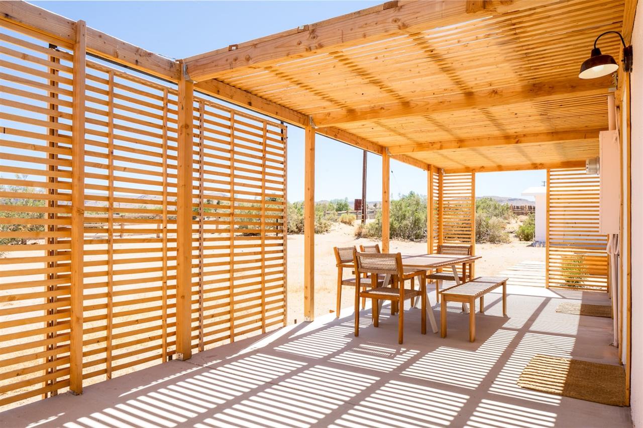 Outdoor dining room with views of the desert and neighboring horses