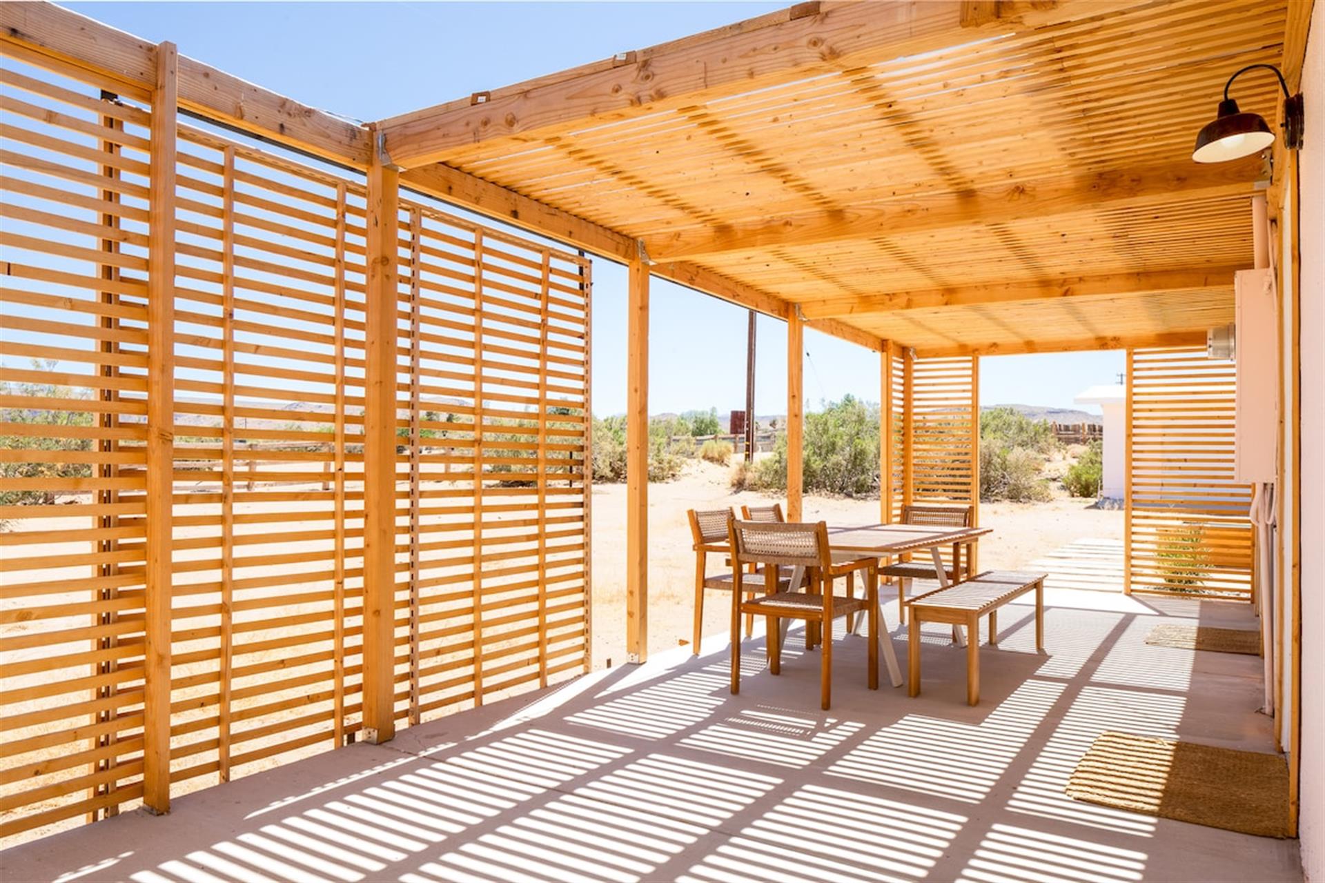 Outdoor dining room with views of the desert and neighboring horses