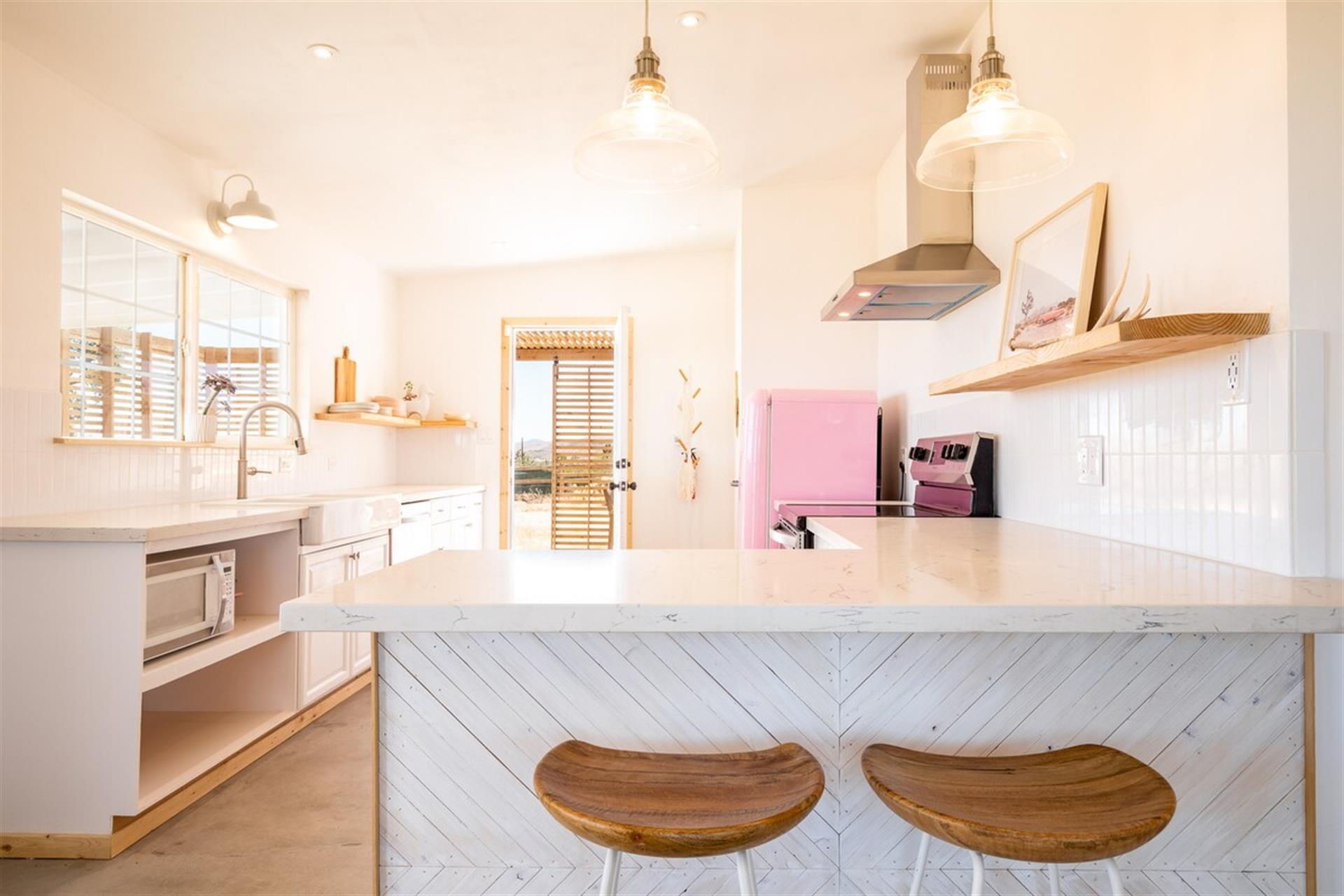Full kitchen and breakfast bar and side door to additional outdoor seating