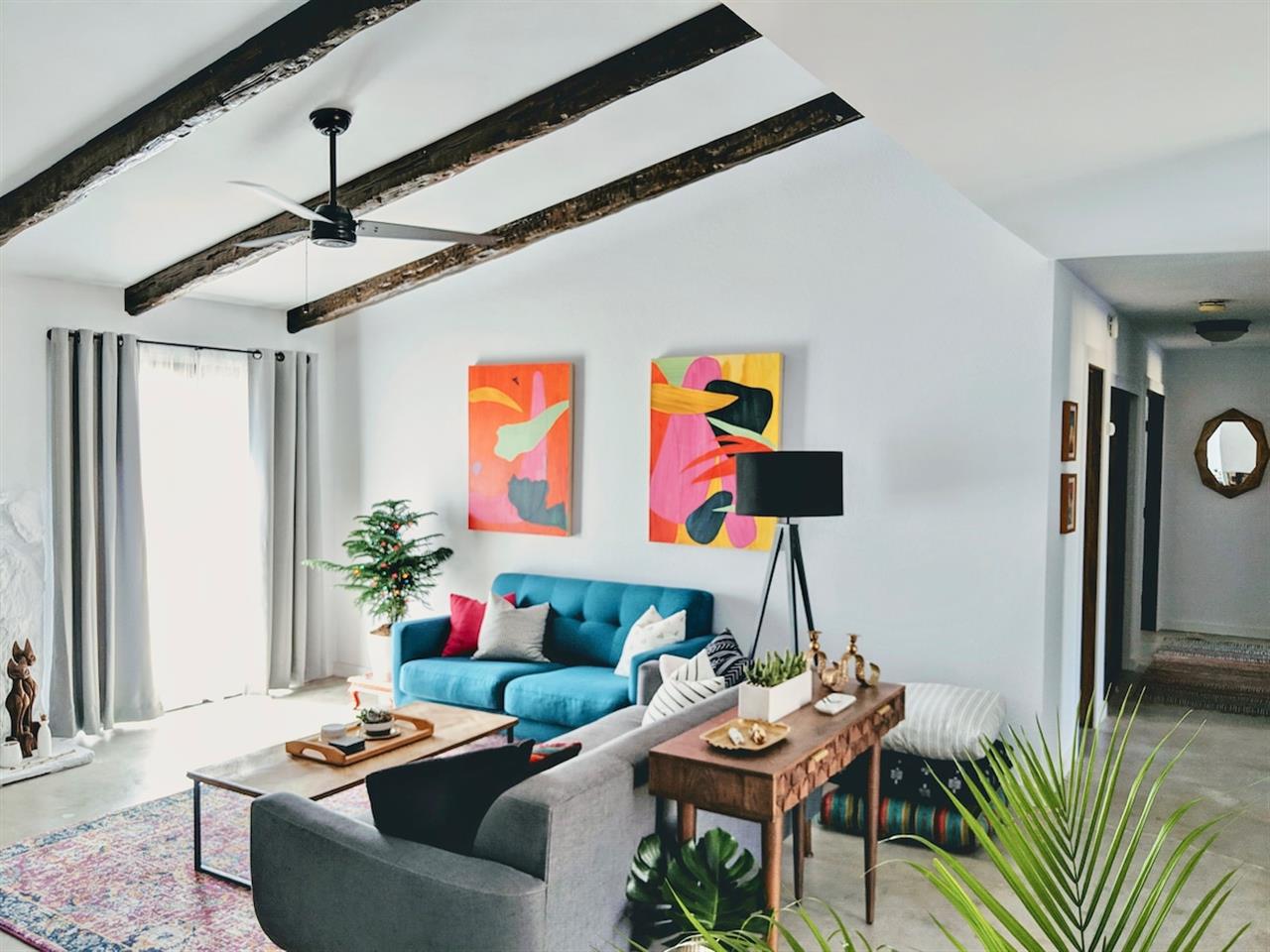 Living Room with love seat, sofa and floor cushions.