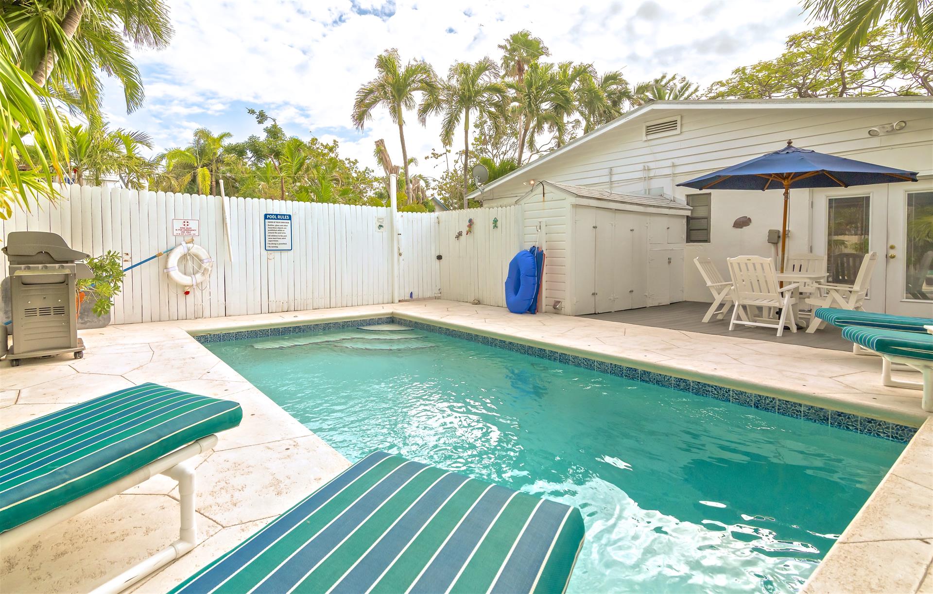 Pool also features shaded seating area  large gas grill