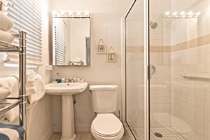 Ensuite with pedestal sink and walk in shower.