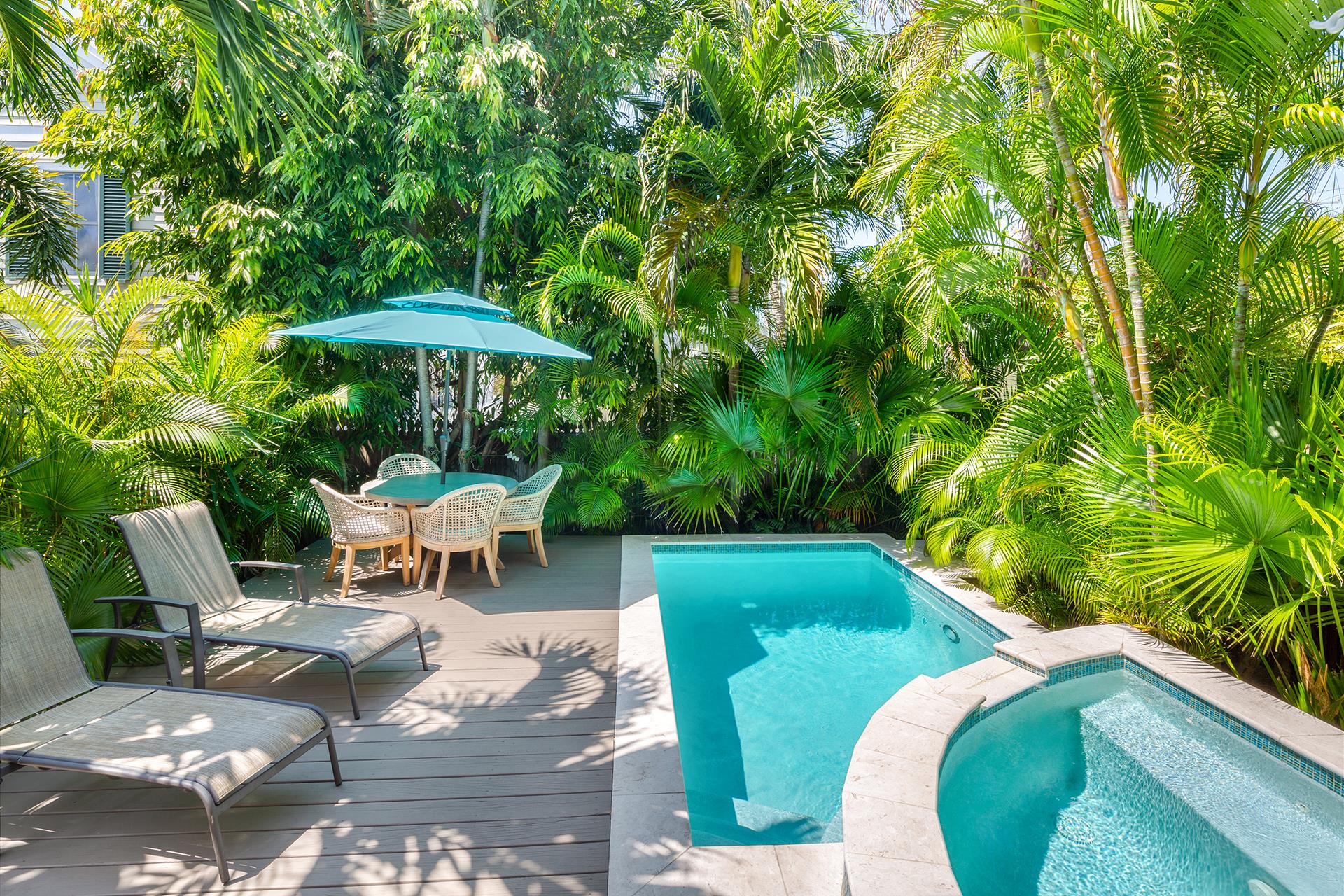 Private cocktail pool with sitting pool and water feature.