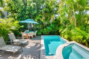 Private cocktail pool with sitting pool and water feature.