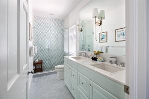 Opulent ensuite with double sinks and walkin shower.