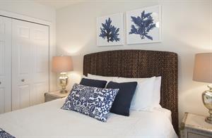 Cozy queen bed with bedside lighting.