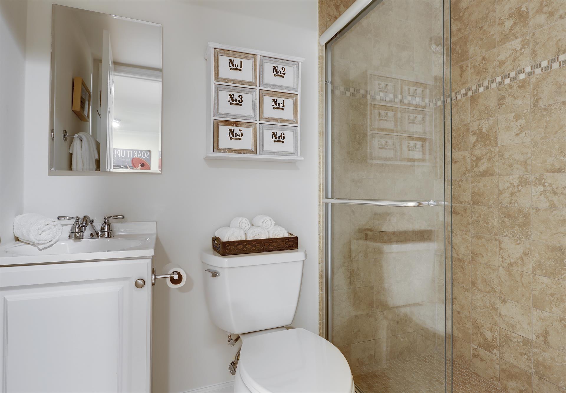 Updated bathroom with tiled, walkin shower.