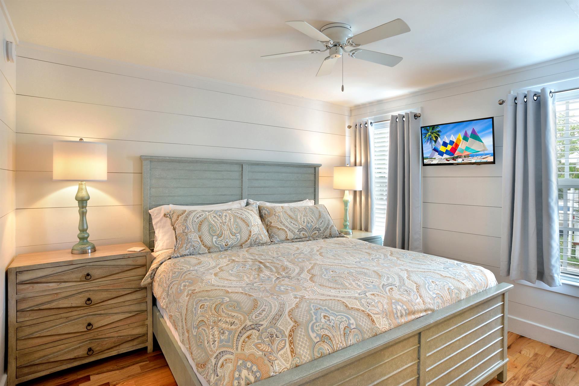 Comfy king bed with flat screen TV and bedside lighting.