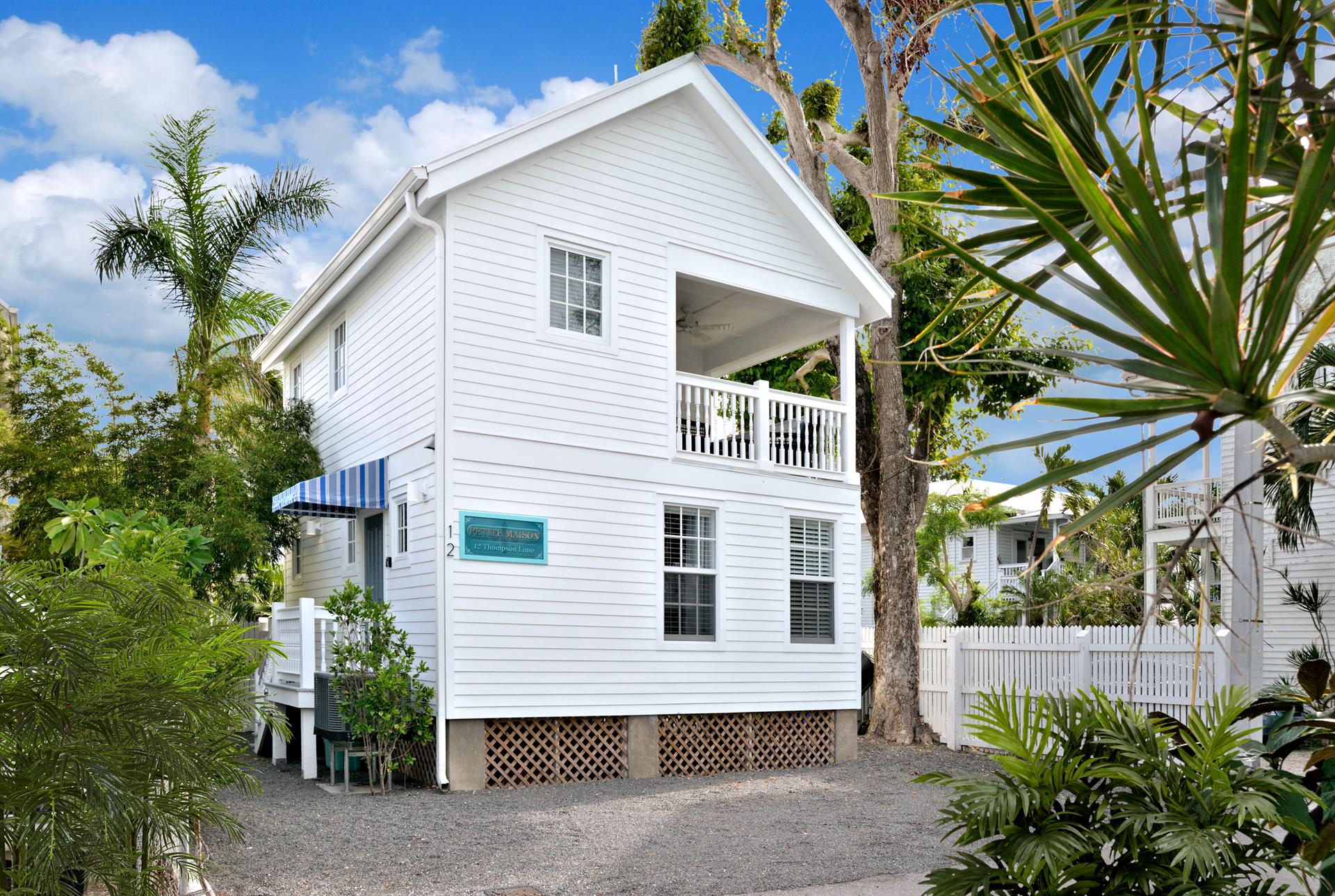 Exterior view of home and off street parking for one car.