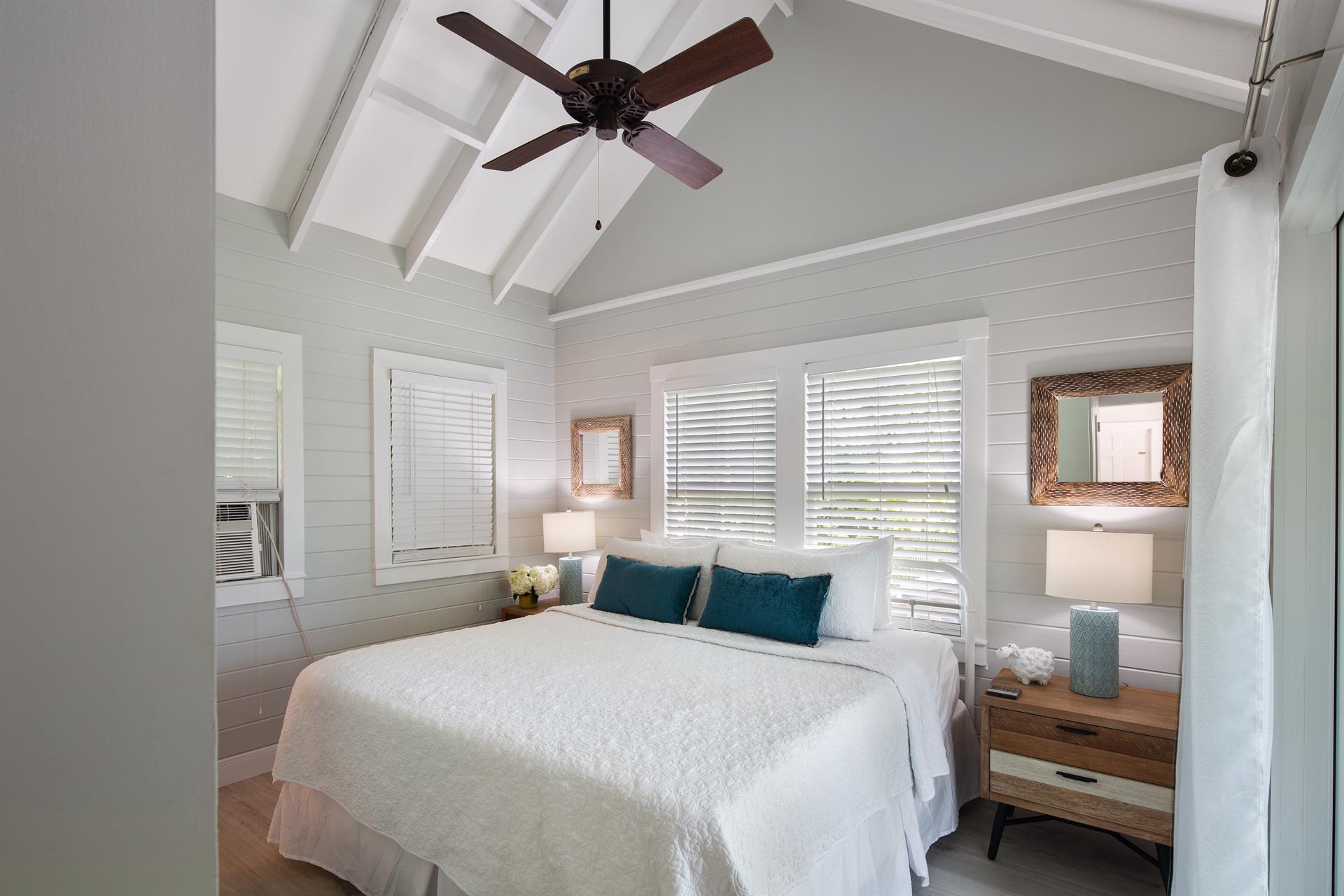 Upstairs king bedroom with vaulted ceiing and window AC.