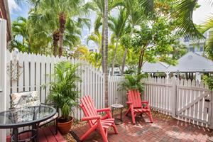 Shaded outdoor patio w plenty of seating.