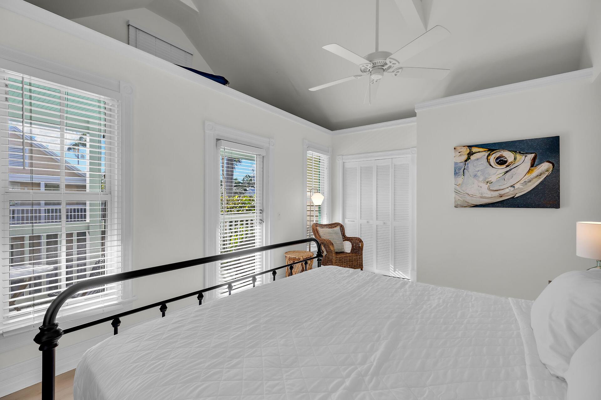 Primary king bedroom with access to private balcony.