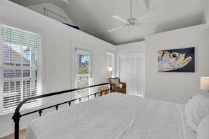 Primary king bedroom with access to private balcony.