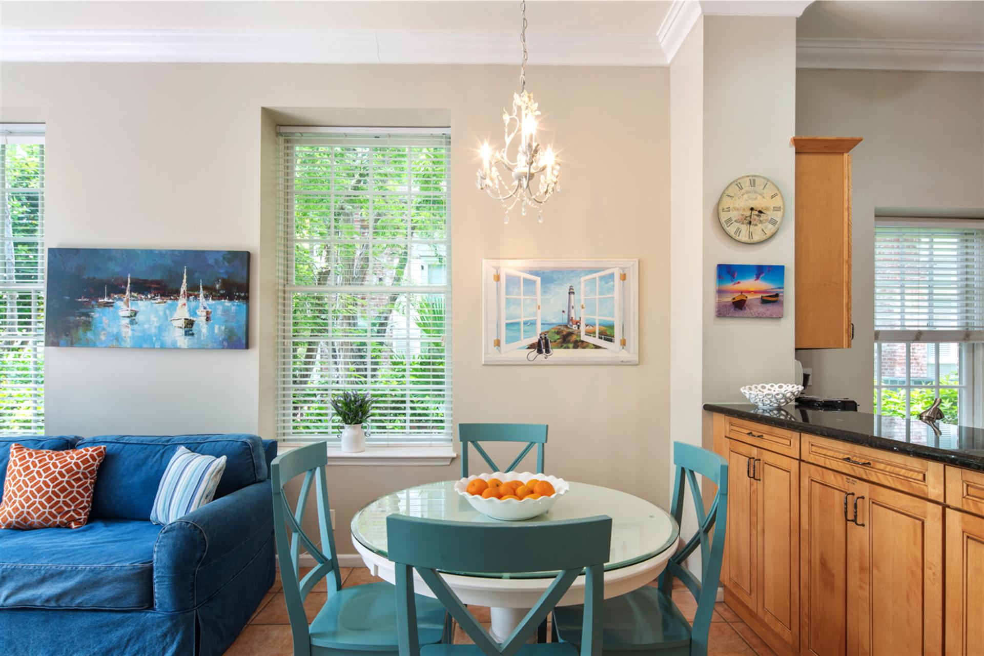 Dining area lies beneath an elegant chandelier.