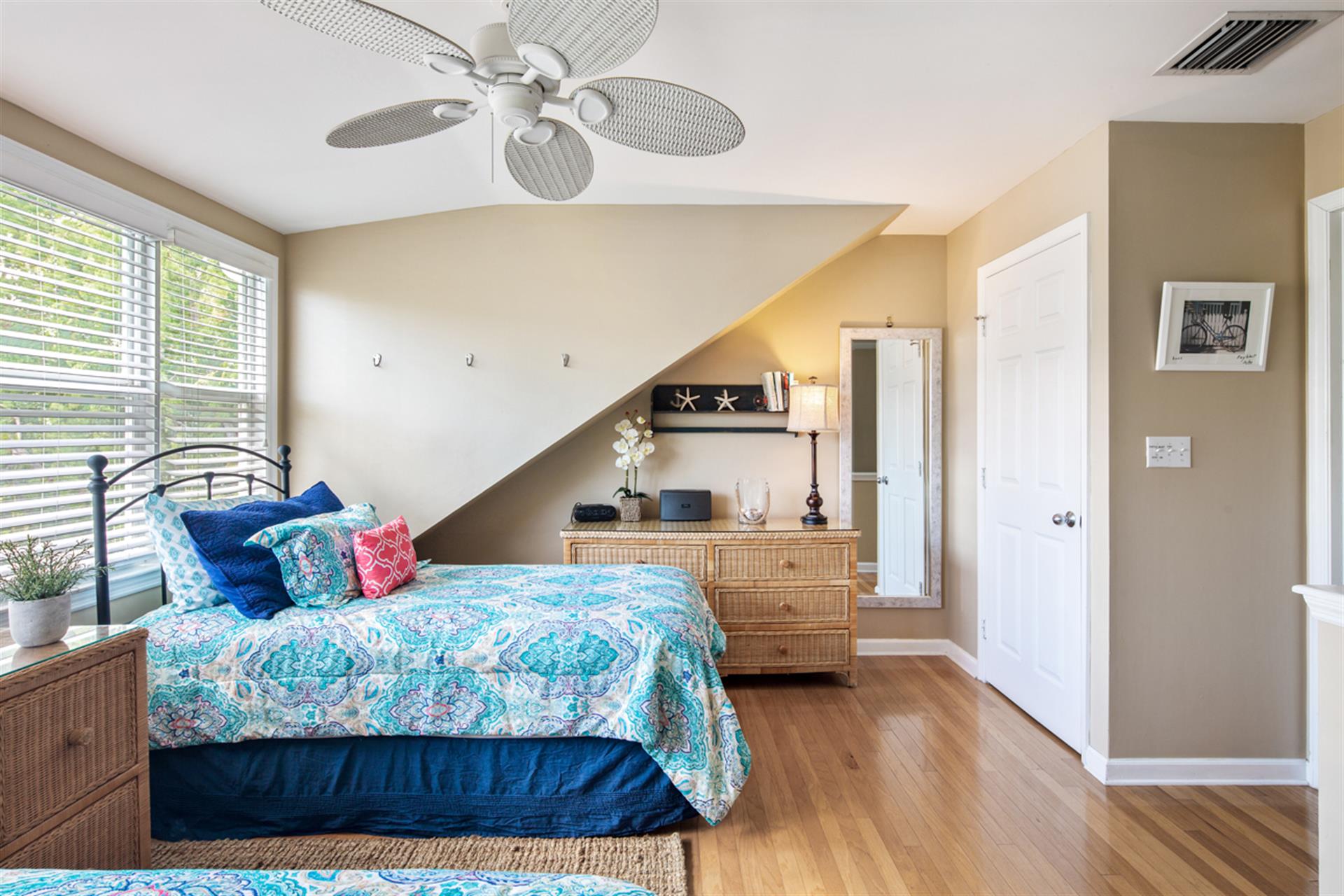 Guest bedroom includes closet and dresser storage.