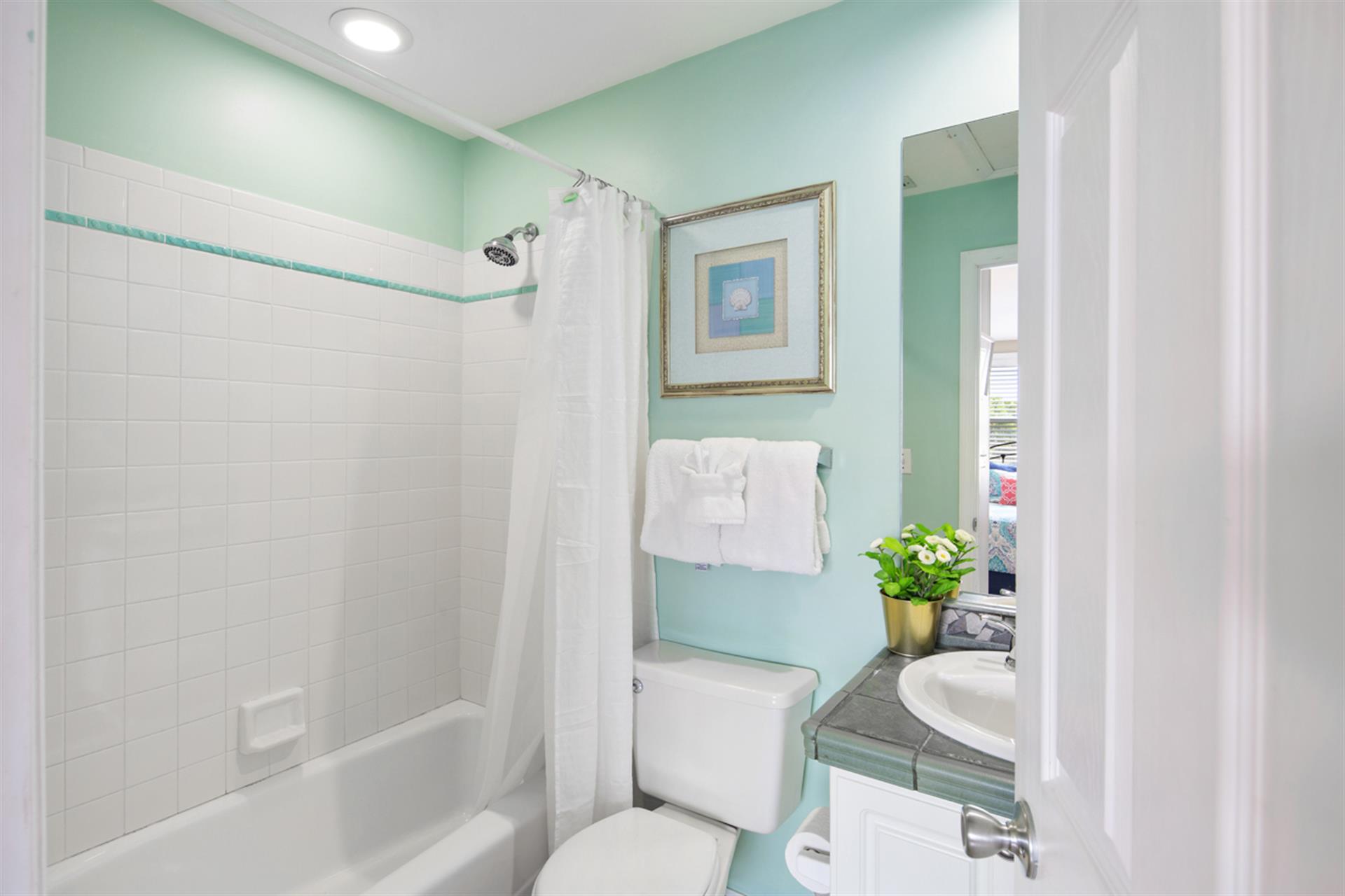 Guest bathroom includes shower  tub combo.
