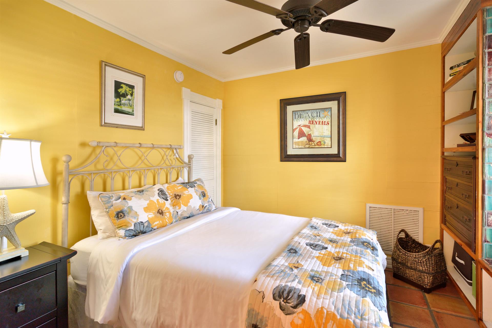 Downstairs queen bedroom is cozy and bright.