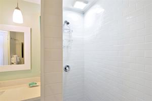 Downstairs full bathroom with subway tiled walkin shower.