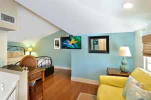 Upstairs primary bedroom includes seating and desk for working