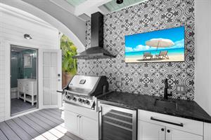 Full outdoor kitchen ,TV, and cottage bath access as well