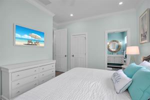 Guest bedroom with dresser, closet, and TV.