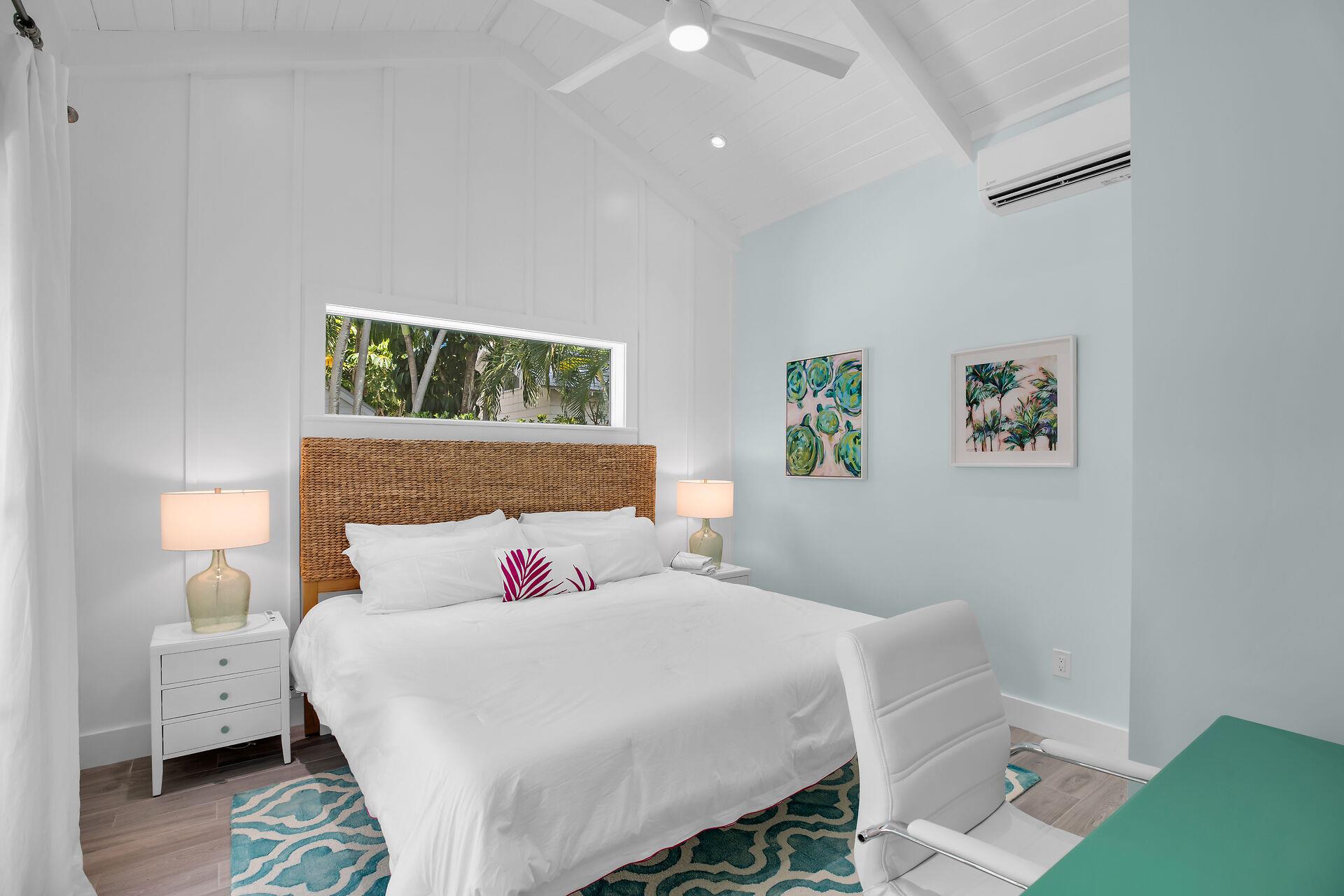 Spacious guest room in cottage with vaulted ceilings.