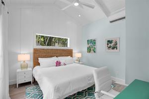 Spacious guest room in cottage with vaulted ceilings.