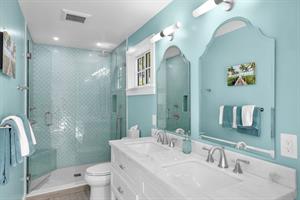 Cottage bath with double sinks and walk in shower