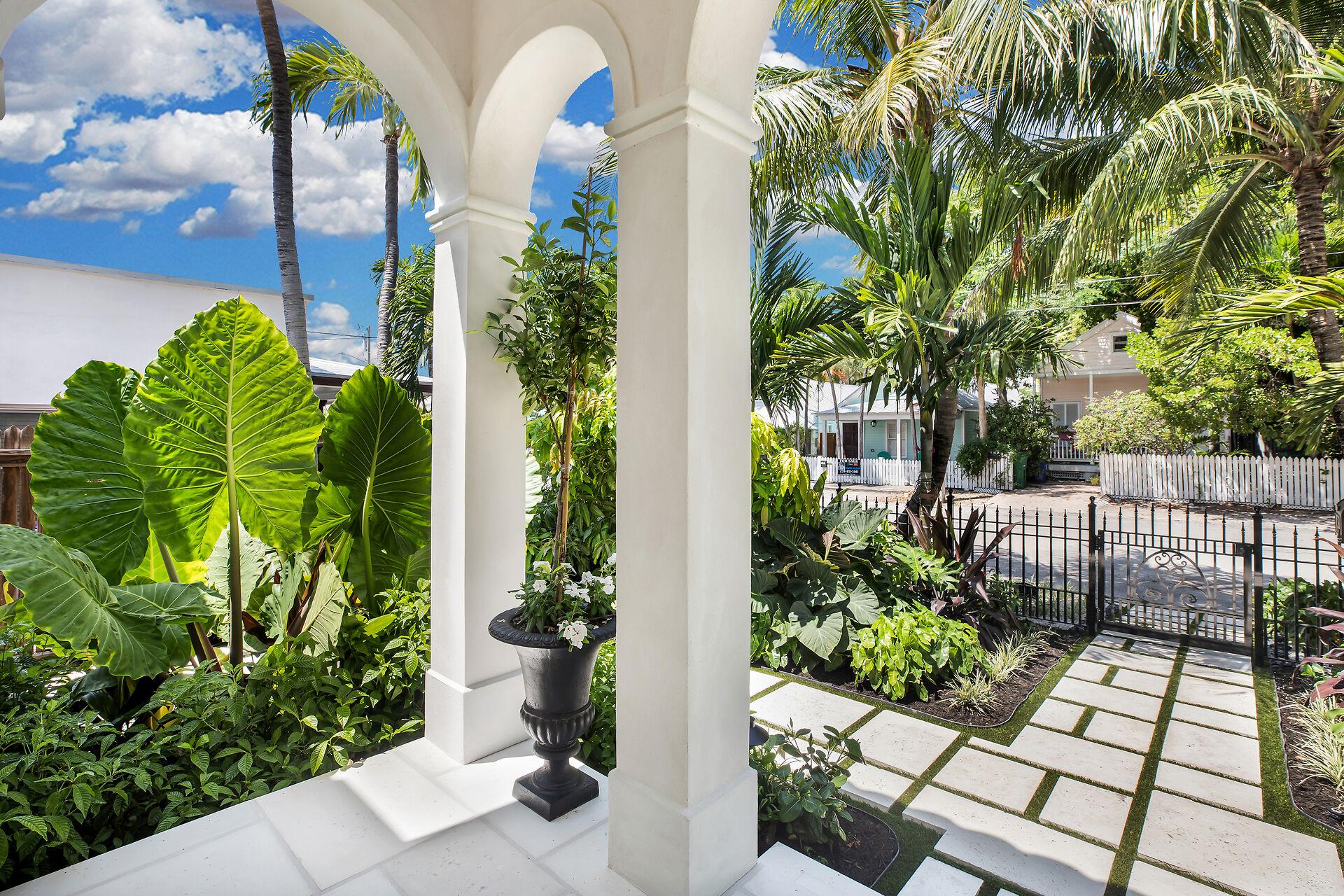 Pristine walkway to the wrought iron gate.