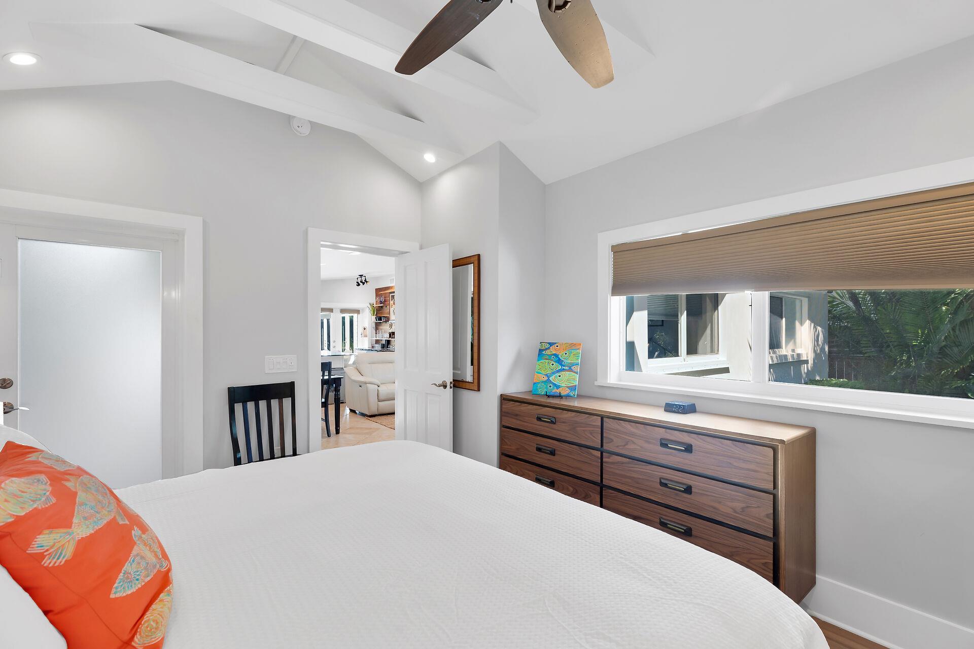 Primary king with ceiling fan and natural light