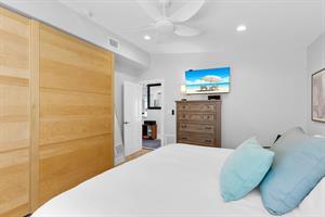 King guest bedroom with TV, closet and dresser