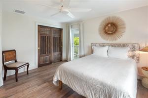 Second floor queen bedroom with balcony access.