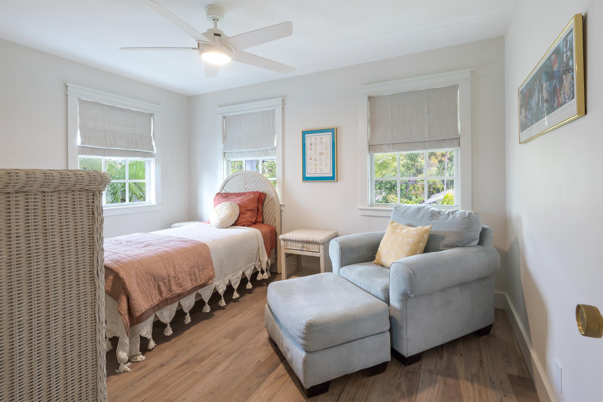 Second floor twin bedroom with comfy seating.