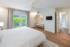 Primary suite with balcony access.