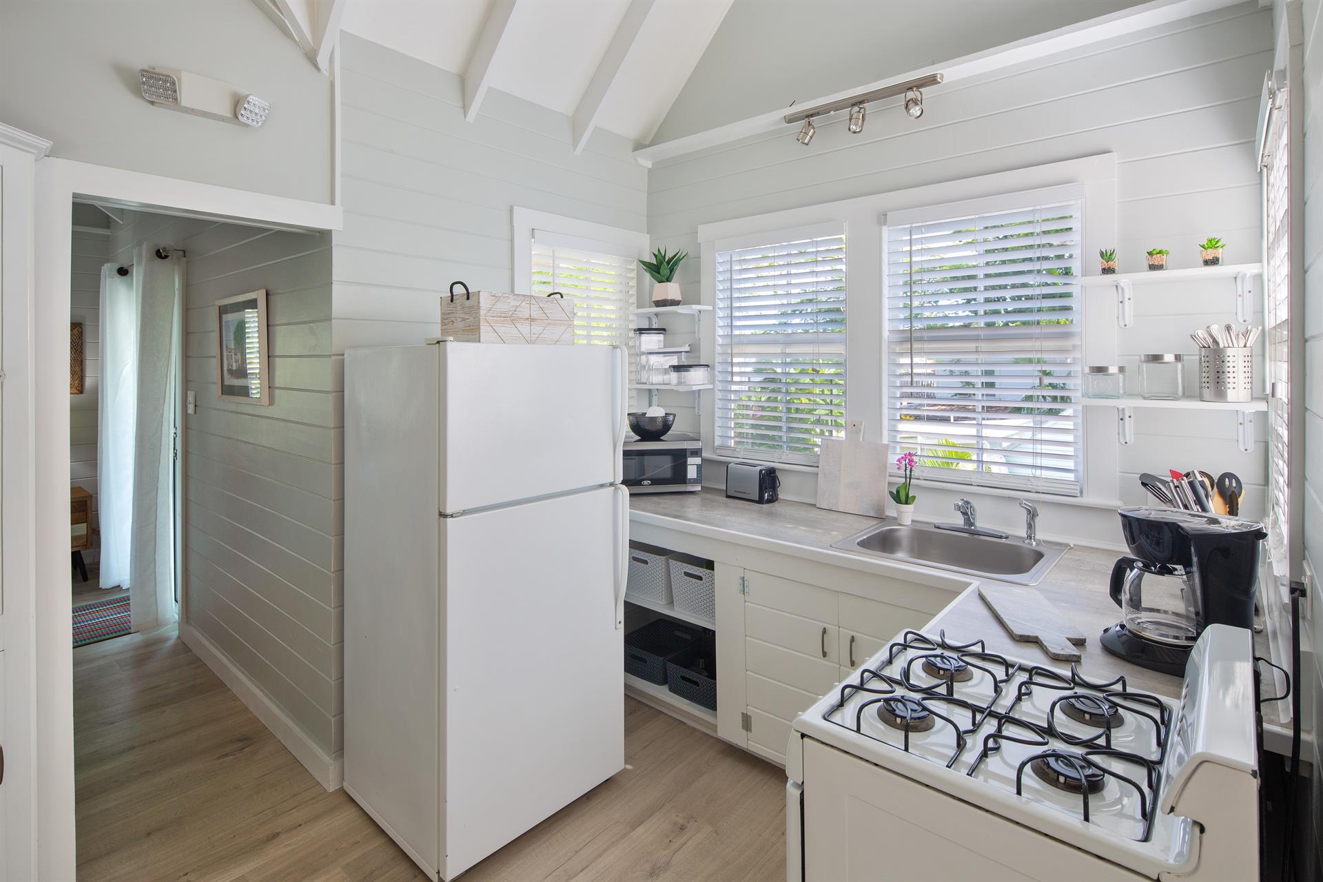View of kitchen and hallway leading back to bedroom.