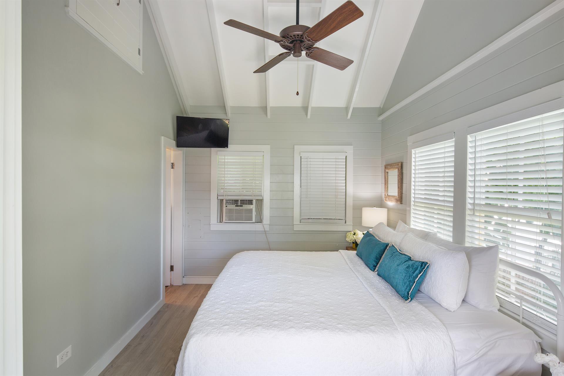 King bedroom with flat screen TV and ensuite bath.