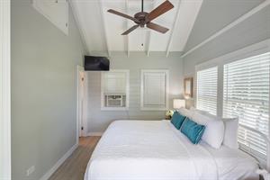 King bedroom with flat screen TV and ensuite bath.