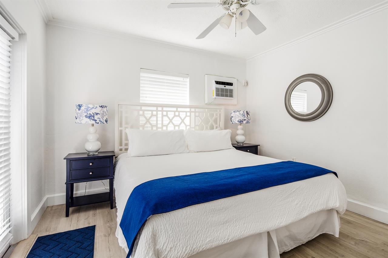 King bedroom has bedside lighting and wall AC