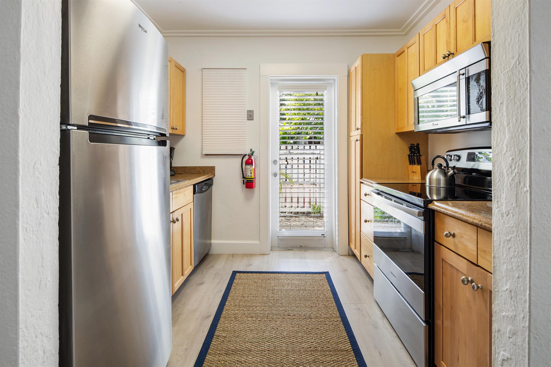 Stainless steel appliances and access to outdoors.