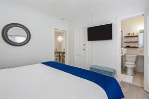 King bedroom with TV and ensuite bath