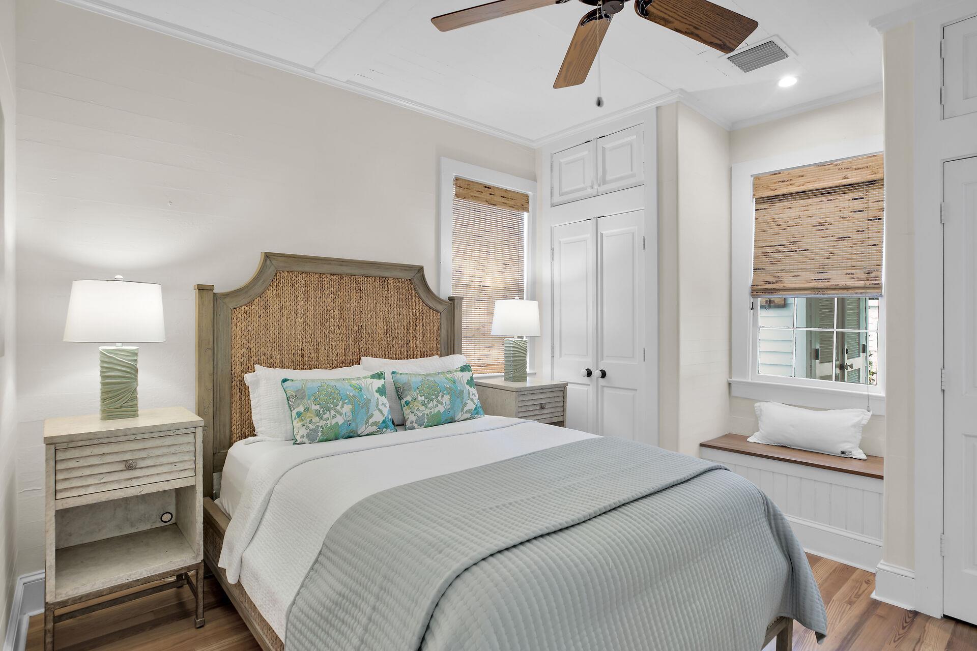 Second bedroom with queen bed and bedside lighting.