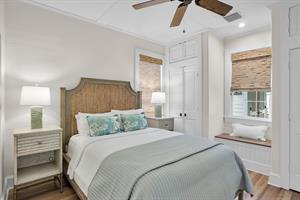 Second bedroom with queen bed and bedside lighting.